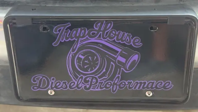 Purple Trap House Diesel Performance license plate on a truck bumper