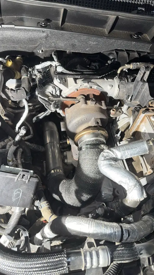 Diesel engine bay with the intake and turbo piping exposed