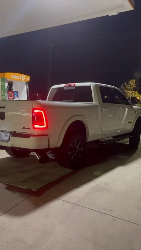 White Ram pickup at night with its LED taillights on