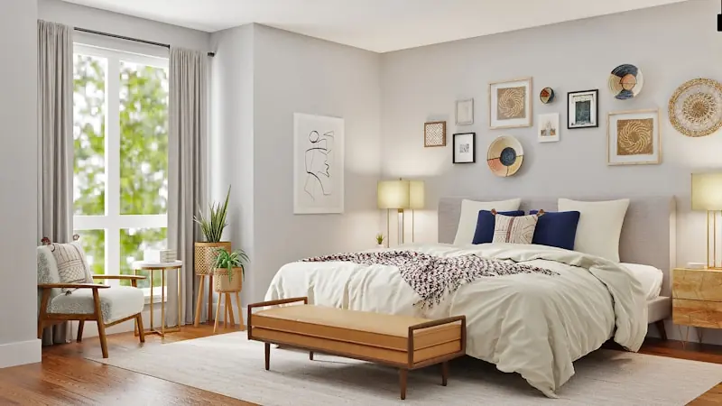 Dormitorio cálido con cama de ropa blanca, banca de madera al pie y cuadros en la pared